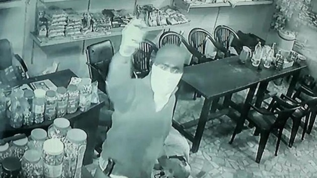 One of the gunmen inside the canteen.(CCTV grab)