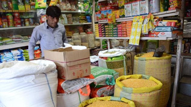 A trader sells groceries in his shop.(HT File photo)
