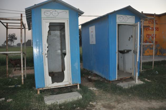 Toilets built under the Swachh Bharat Mission in one of the villages adopted by Prime Minister Narendra Modi are now in a broken state.(HT Photo)