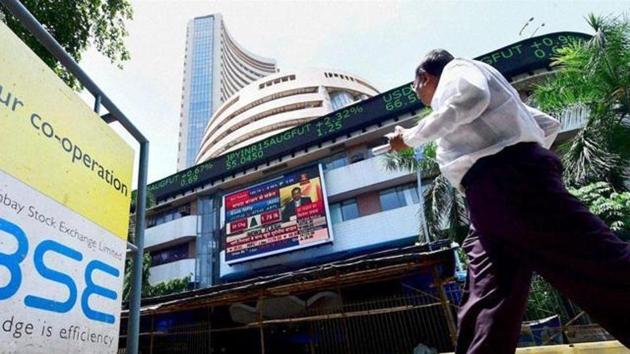 A man walks past BSE (PTI Photo) A man walks past BSE (PTI Photo)