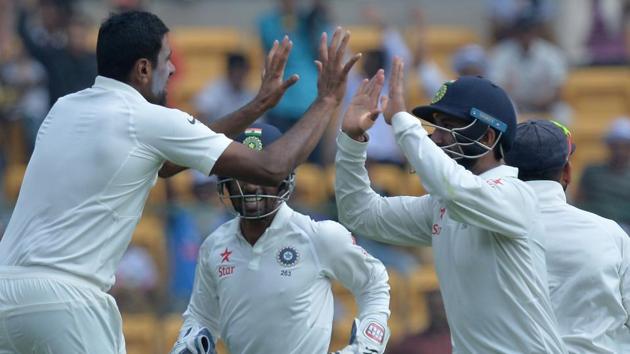 Ravichandran Ashwin (left) could manage just two wickets in the first innings but he surpassed coach Anil Kumble’s record of most balls bowled in a Test season by sending 3749 balls till the end of Australian innings on Day 3 of the second Test at M Chinnaswamy Stadium in Bangalore on Monday. (AFP)