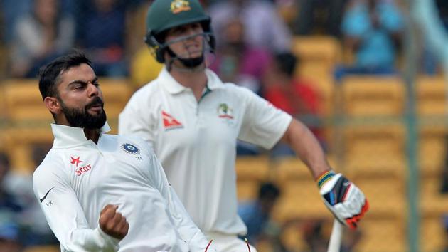 Virat Kohli celebrates after the dismissal of Australian batsman Mitchell Marsh on Day 2 of the second Test match between India and Australia in Bangalore on Sunday.(AFP)