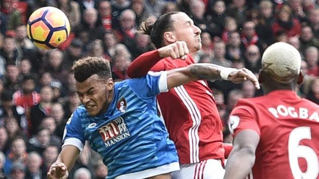 Manchester United's Zlatan Ibrahimovic (2L) clashes in the air with Bournemouth's Tyrone Mings (L) during their Premier League match.(AFP)