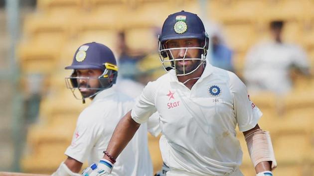 Cheteshwar Pujara and Ajinkya Rahane run between the wickets during third day of the second Test match against Australia at Chinnaswamy stadium in Bangalore on Monday. At close, India have a lead of 126 runs. Full cricket scorecard of India vs Australia here.(PTI)