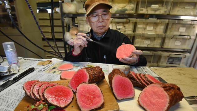 Noriyuki Mishima, a craftsman at Fake Food Hatanaka, spraying paint on a plastic food replica that restaurants across Japan put in their display windows to lure hungry crowds, at the company's studio in Tokorozawa, a suburb of Tokyo. They may look good enough to eat, but Japan's mouthwatering food replicas are only for show as restaurateurs compete for the attention of hungry customers. (TORU YAMANAKA / AFP) Noriyuki Mishima, a craftsman at Fake Food Hatanaka, spraying paint on a plastic food replica that restaurants across Japan put in their display windows to lure hungry crowds, at the company's studio in Tokorozawa, a suburb of Tokyo. They may look good enough to eat, but Japan's mouthwatering food replicas are only for show as restaurateurs compete for the attention of hungry customers. (TORU YAMANAKA / AFP)