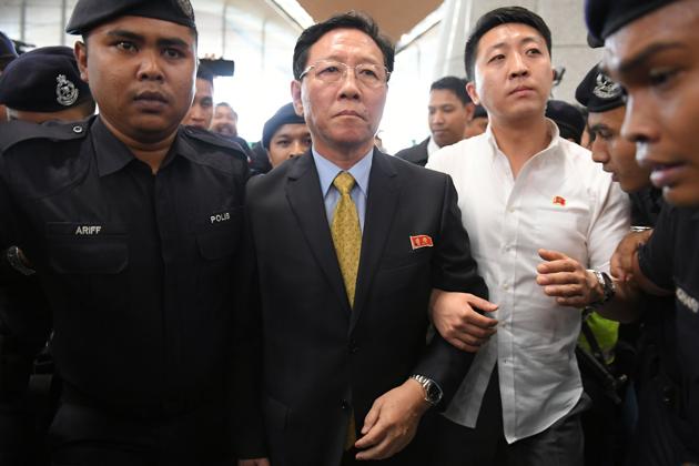 Expelled North Korean ambassador to Malaysia Kang Chol (centre) is escorted by police to the departure hall of the Kuala Lumpur International Airport in Sepang on Monday. (AFP)