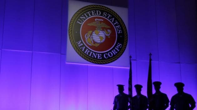 A US Marine Corps Color Guard sands under a Marine Corps emblem in Jupiter, Florida. (AP File Photo) A US Marine Corps Color Guard sands under a Marine Corps emblem in Jupiter, Florida. (AP File Photo)