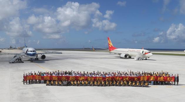 A file photo released by China's Xinhua News Agency shows people posing for a group photo after landing at the airfield on Fiery Cross Reef in the Spratly Islands.(AP File/ Representational Photo)