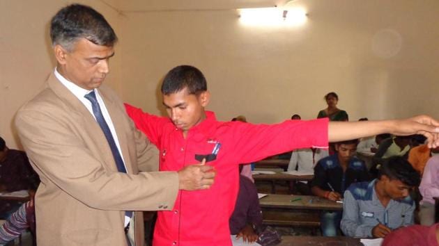 Patna divisional commissioner Anand Kishor checks an examinee at an examination centre in Patna. (Santosh Kumar/HT Photo) Patna divisional commissioner Anand Kishor checks an examinee at an examination centre in Patna. (Santosh Kumar/HT Photo)