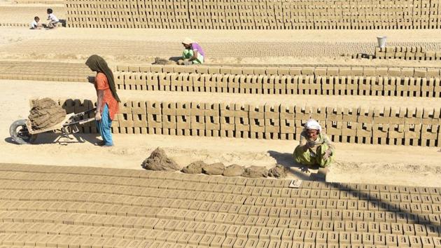 Women making bricks of mud at a village near Amritsar. (Gurpreet Singh/HT Photo) Women making bricks of mud at a village near Amritsar. (Gurpreet Singh/HT Photo)