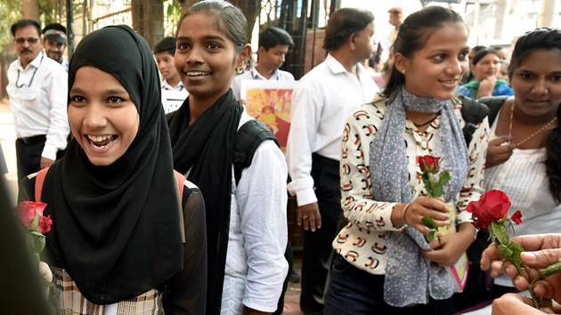 Students are welcomed with flowers on the first day of Secondary School Certificate exams at Saraswati Mandir High School in Mahim area of Mumbai on Tuesday. (Kunal Patil/HT)