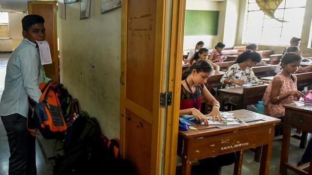 As others write their exam, one SSC student enters late at Saraswati Mandir High School at Mahim in Mumbai. The board has instructed supervisors to make a separate note of students walking into the exam rooms after 11.00 am after five HSC papers leaked on WhatsApp. (Kunal Patil/HT Photo)