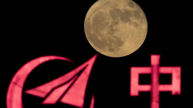 In this photo, the supermoon rises over a logo for AVIC, or Aviation Industry Corp, a state owned enterprise involved in China's manned space mission in Beijing. (AP Photo/ Representative image) In this photo, the supermoon rises over a logo for AVIC, or Aviation Industry Corp, a state owned enterprise involved in China's manned space mission in Beijing. (AP Photo/ Representative image)