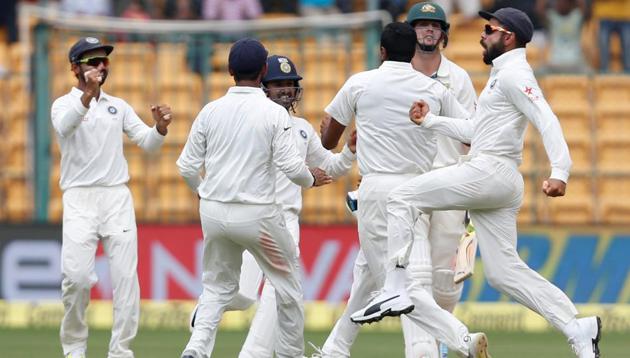 India captain Virat Kohli (right) celebrates the wicket of Australia's Mitchell Marsh in Bangalore on Tuesday.(REUTERS)