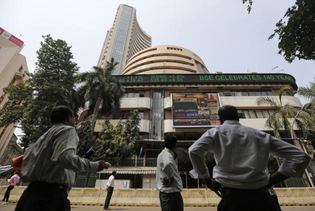 People look at a screen on a facade of the Bombay Stock Exchange (BSE) building in Mumbai (Reuters) People look at a screen on a facade of the Bombay Stock Exchange (BSE) building in Mumbai (Reuters)