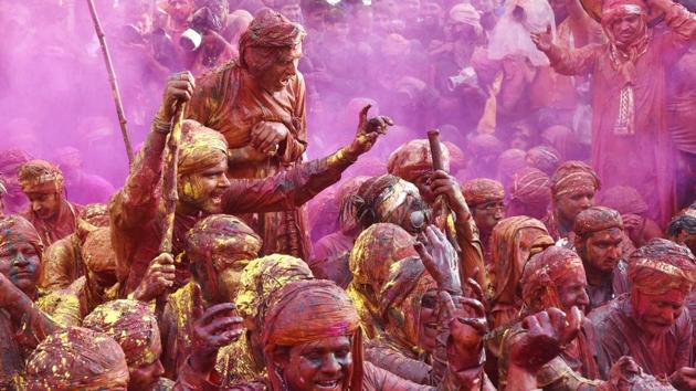 The festival is known to recreate the legendary story, where Lord Krishna,who hailed from Nandgaon, is driven out of Barsana by Radha and her friends after teasing them. (Ajay Aggarwal/HT PHOTO)