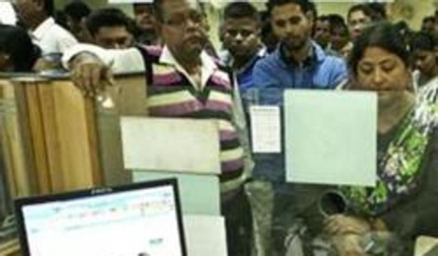 Indians deposit discontinued notes in a bank in Guwahati, India, after the government demonetised high-value currency notes in a surprise move on November 8. (AP) Indians deposit discontinued notes in a bank in Guwahati, India, after the government demonetised high-value currency notes in a surprise move on November 8. (AP)