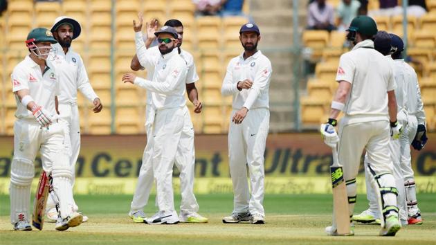 Indian cricket team players celebrate after Ravichandran Ashwin took the wicket of David Warner. (PTI)