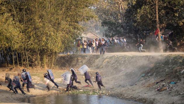 Nepalese riot police run for cover as Madhesi activists hurl stones at them in Saptari district on March 6, 2017.(Reuters)