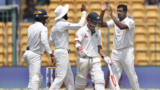 India's Ravichandran Ashwin, right, celebrates with teammates the dismissal of Australia's David Warner. (AP)