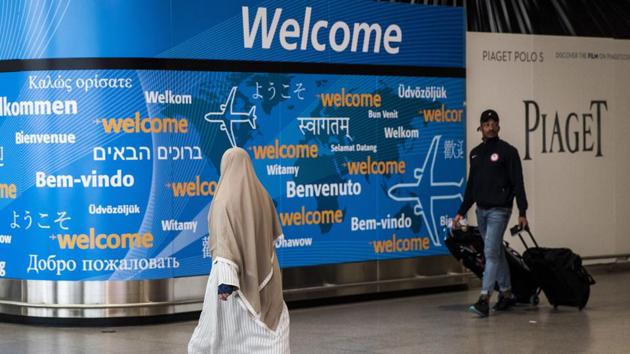Travellers arrive at the international terminal at John F Kennedy International Airport in New York City. A new “worldwide caution” issued by the US state department has warned American travellers that “extremist elements are also active in India”.(AFP Photo)