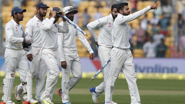 Virat Kohli leads his Indian teammates off the field after their win over Australia in the second Test.(AP)