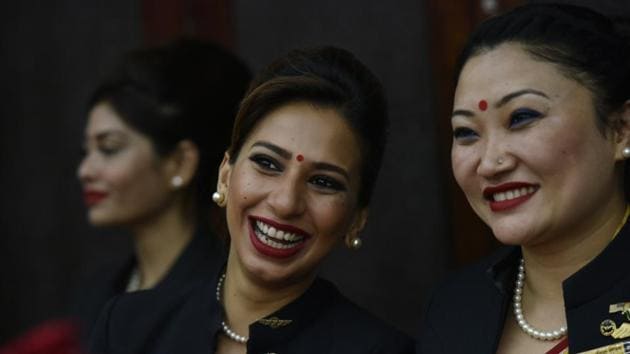 Air India cabin crew of a Boeing 777-200LR share a light moment during a ceremony to celebrate the eve of International Women's Day in New Delhi. Air India says it has set a world record by circumnavigating the globe with an all woman flight and cabin crew. Press Trust of India reported that the flight flew over the Pacific Ocean from New Delhi to San Francisco last Monday, and then flew back to New Delhi over the Atlantic on Friday. (Vipin Kumar/HT PHOTO)