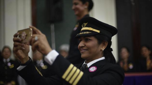 An Air India pilot takes pictures of another colleague during the ceremony and media interaction. The first woman pilot of AI (erstwhile Indian Airlines) was inducted in 1956. (Vipin Kumar/HT PHOTO)