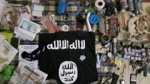 An Islamic State flag and other items seized by the Uttar Pradesh Anti-Terrorist Squad from a building where a suspected militant was holed up.