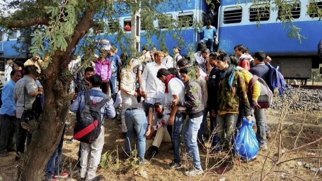 People attend to an injured person after a blast in the Bhopal-Ujjain passenger train near Jabdi station in Shajapur district in Madhya Pradesh on Tuesday.(PTI Photo)