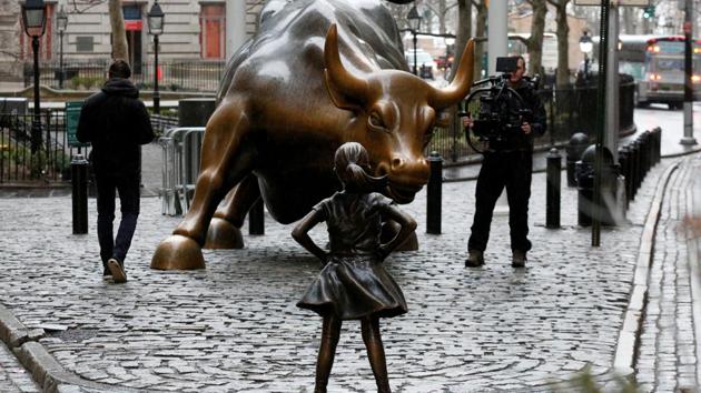 A camera man films a statue of a girl facing the Wall St. Bull, as part of a campaign by U.S. fund manager State Street to push companies to put women on their boards, in the financial district in New York, U.S., March 7, 2017. REUTERS/Brendan McDermid(REUTERS)