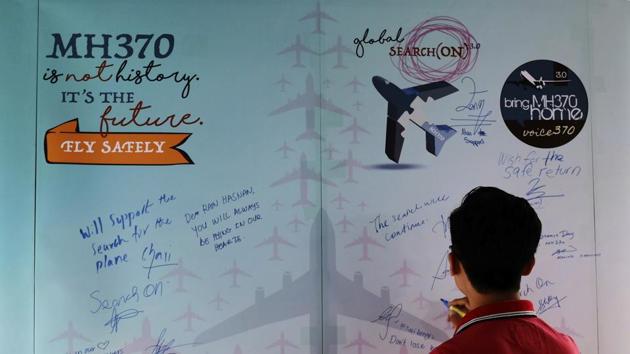A man writes a condolence message during the Day of Remembrance for MH370 event in Kuala Lumpur, Malaysia. (AP File Photo) A man writes a condolence message during the Day of Remembrance for MH370 event in Kuala Lumpur, Malaysia. (AP File Photo)