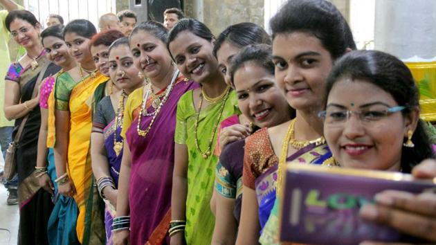 Women pose for a photo during an event organised by the Central Railway. (Bhushan Koyande/ht photo)