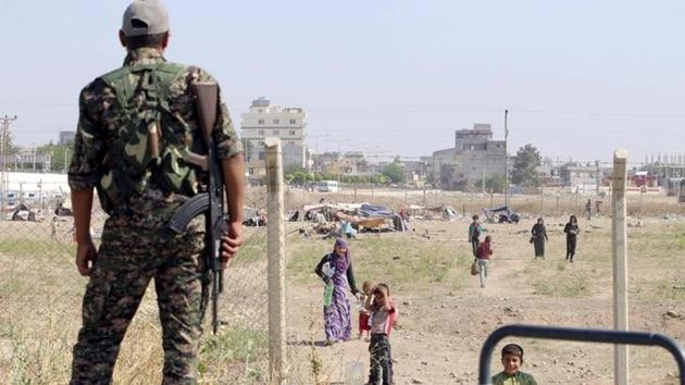 A Kurdish People's Protection Units (YPG) fighter looks at makeshift tents between the Syrian and Turkish borders of residents who fled Maskana town in the Aleppo countryside, as he stands in Tel Abyad town, Raqqa governorate, Syria.(Reuters File Photo) A Kurdish People's Protection Units (YPG) fighter looks at makeshift tents between the Syrian and Turkish borders of residents who fled Maskana town in the Aleppo countryside, as he stands in Tel Abyad town, Raqqa governorate, Syria.(Reuters File Photo)