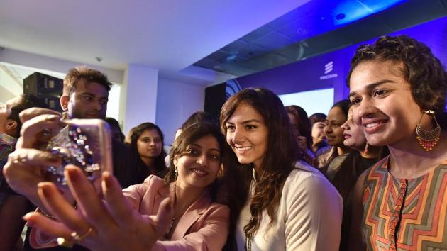 Women click selfies with Geeta Phogat (centre) and Babita Phogat (right) at a function held on Women’s Day. (Sanjeev Verma/HT PHOTO) Women click selfies with Geeta Phogat (centre) and Babita Phogat (right) at a function held on Women’s Day. (Sanjeev Verma/HT PHOTO)