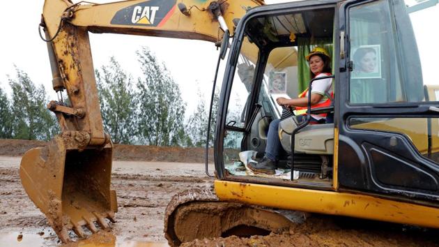 Filipina Grace Ocol, 40, a backhoe operator, poses for a photograph in Tubay, Agusan del Sur, southern Philippines, February 16, 2017. Ocol, a mother of three, said, ‘There are a few female workers that can drive big trucks and backhoe. If men can do it, why can't women do it? I'm better than the men, they can only drive trucks here but I can drive both.’ (Erik De Castro / REUTERS)