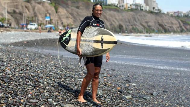 Rocio Larranaga, 53, a surfer and surf instructor, poses for a photograph at Redondo beach in Lima, Peru, February 23, 2017. (Guadalupe Pardo / REUTERS)