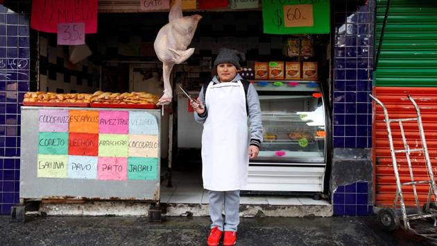 Cristina Alvarez, 29, a butcher, poses for a photograph while standing outside her and her husband's butcher shop, in Mexico City, Mexico February 25, 2017. ‘I've never felt any gender inequality,’ Alvarez said. ‘I believe women can do the same jobs as men and that there should be no discrimination.’ (Jose Luis Gonzalez / REUTERS)
