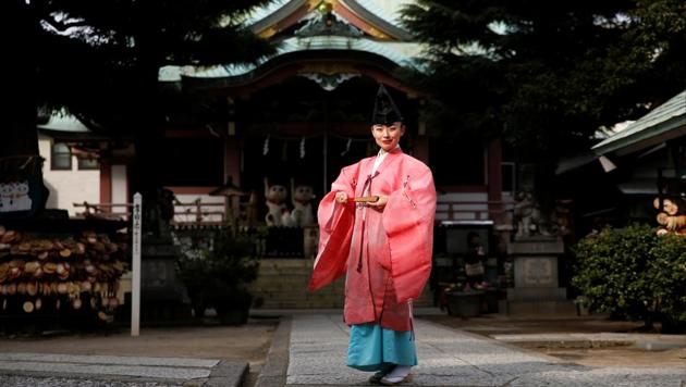 Shinto priest Tomoe Ichino, 40, poses for a photograph at the Imado Shrine in Tokyo, Japan, February 22, 2017. ‘In general, people think being a Shinto priest is a man's profession. If you're a woman, they think you're a shrine maiden, or a supplementary priestess. People don't know women Shinto priests exist, so they think we can't perform rituals. Once, after I finished performing jiichinsai (ground-breaking ceremony), I was asked, 'So, when is the priest coming?',’Ichino said. ‘When I first began working as a Shinto priest, because I was young and female, some people felt the blessing was different. They thought: 'I would have preferred your grandfather.' At first, I wore my grandfather's light green garment because I thought it's better to look like a man. But after a while I decided to be proud of the fact that I am a female priest and I began wearing a pink robe, like today. I thought I can be more confident if I stop thinking too much (about my gender).’ (Toru Hanai / REUTERS)