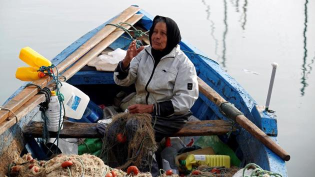 Chrifa Nimri, 69, a fisherwoman, arranges a net after returning from fishing at the seaport Sidi Bou Said, in Tunis, Tunisia, February 23, 2017. ‘At the beginning of my fishing career all the world told me that the trade was for men but now all my colleagues respect and call me captain,’ Chrifa said. (Zoubeir Souissi / REUTERS)