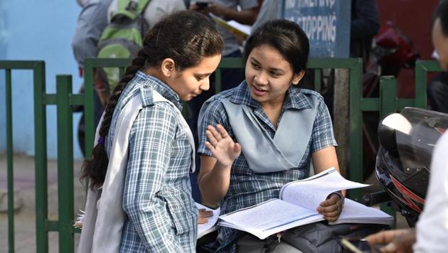 Students wait outside their examination centre  at Kendriya Vidyalaya in New Delhi. (Saumya Khandelwal/HT PHOTO) 