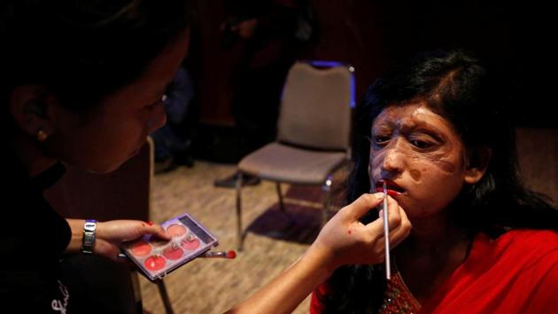 A Bangladeshi acid attack survivor gets her make up applied . (Mohammad Ponir Hossain / REUTERS)