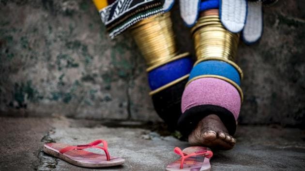 South African artist Esther Mahlangu  shows the rings and ankle-wear common to Ndebele women.  (GULSHAN KHAN / AFP) 
