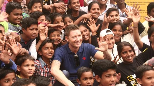 Former Australia captain Michael Clarke spent time with some underprivileged children at a city slum on Friday.(HT Photo)