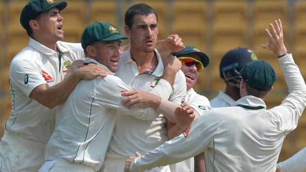 Mitchell Starc (centre) celebrates with teammates the dismissal of Indian batsman Karun Nair during the fourth day of the second Test match between India and Australia in Bangalore on March 7, 2017. India won the Test by 75 runs(AFP)