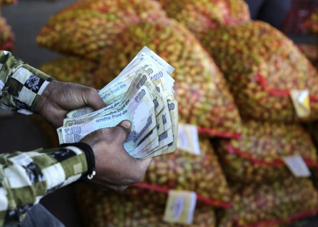An Indian trader counts rupees at wholesale vegetables market on the outskirts of Jammu, India, Monday, March 6, 2017. India's economy registers a faster-than-expected growth of 7 per cent in fiscal third quarter 2016-17, notwithstanding the demonetization of high-value banknotes in November that caused immense hardship to small businesses dependent on cash transactions. (AP Photo/Channi Anand) (AP) An Indian trader counts rupees at wholesale vegetables market on the outskirts of Jammu, India, Monday, March 6, 2017. India's economy registers a faster-than-expected growth of 7 per cent in fiscal third quarter 2016-17, notwithstanding the demonetization of high-value banknotes in November that caused immense hardship to small businesses dependent on cash transactions. (AP Photo/Channi Anand) (AP)