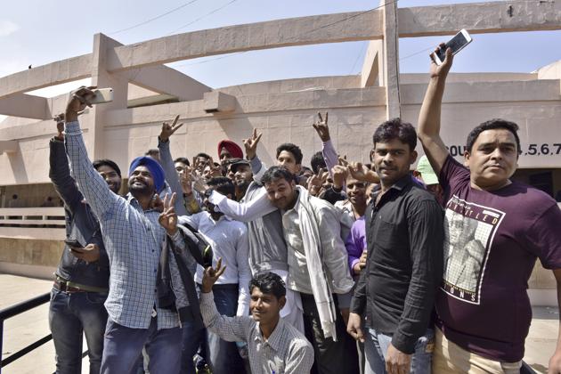 Maruti workers who were accused in the 2012 factory violence case celebrate after their acquittal at the district court in Gurgaon on Friday.(Sanjeev Verma/HT Photo)