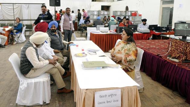 Election officials wait at a counting centre for assembly elections at Polo Grounds in Patiala. (Bharat Bhushan/ht photo)