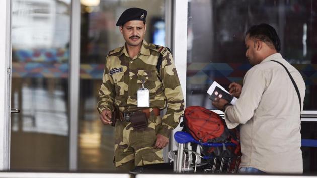 A CISF security personnel stops a passenger for security check at the IGI Airport in New Delhi. (HT File)