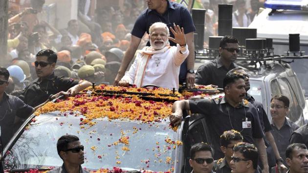 The BJP could emerge as the single-largest party in Uttar Pradesh and get within striking distance of the majority mark in what is seen to be a hung assembly, exit polls said on Thursday. Prime Minister Narendra Modi waves at crowd during his election roadshow in Varanasi on March 4th, 2017. (Arun Sharma/HT PHOTO)